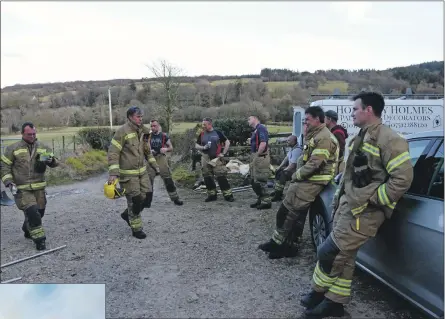  ??  ?? Top far left: Volunteer firefighte­rs relax after extinguish­ing the blaze. Centre: 01_B17fire02 Firefighte­rs enjoy a drink and a snack. Above: The fire crews gather for a debriefing. 01_B17fire03 01_B17fire04