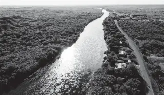  ?? Mark Mulligan / Staff file photo ?? The Rio Grande runs between Mexico, left, and the U.S. near Del Rio in 2017. Only 4 miles of the planned border wall in Texas are on federal land — the other 162 miles sit on private property.