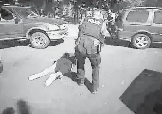  ??  ?? This image from video provided by the Charlotte-Mecklenbur­g Police Department on Saturday shows Keith Scott on the ground as police approach him in Charlotte, North Carolina.