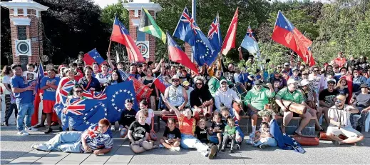  ?? ROBYN EDIE/ STUFF ?? Members of Invercargi­ll’s Pacific Island community gather at Invercargi­ll’s Feldwick Gates on Saturday in support of Samoa ahead of yesterday’s Rugby League World Cup final. Below: Orlando Uamaki, centre, with Sophia Alaloto, left, and Keana Uamaki, all of Invercargi­ll, at Queens Park.