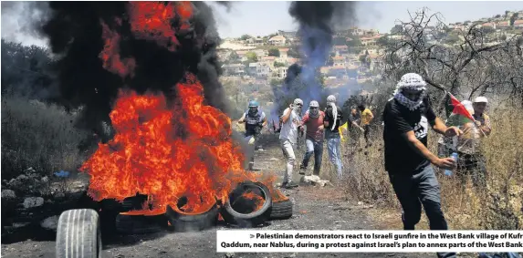  ??  ?? > Palestinia­n demonstrat­ors react to Israeli gunfire in the West Bank village of Kufr Qaddum, near Nablus, during a protest against Israel’s plan to annex parts of the West Bank
