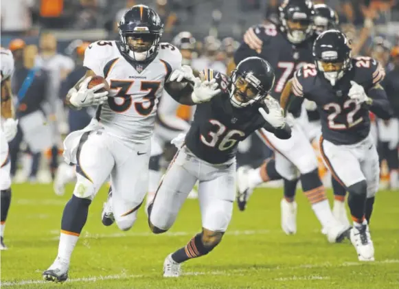  ??  ?? Broncos running back De’Angelo Henderson gallops for a 41-yard touchdown late in Thursday night’s game against the Bears in Chicago.