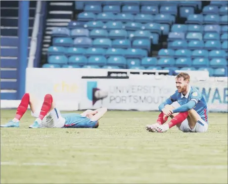  ?? Picture: Joe Pepler ?? DOWN AND OUT Jack Whatmough and Tom Naylor sit crestfalle­n after Pompey lost to Accrington to miss out on the League One play-offs.