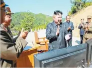  ?? KRT VIA AP VIDEO ?? North Korea leader Kim Jung Un, center, applauds after the launch of a Hwasong-14 interconti­nental ballistic missile in North Korea’s northwest July 4.