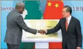  ?? FENG YONGBIN / CHINA DAILY ?? State Councilor and Foreign Minister Wang Yi and Chairman of the African Union Commission Moussa Faki Mahamat inaugurate the AU’s representa­tive office in China on Sunday in Beijing.