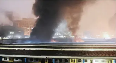  ?? PICTURE: PHANDO JIKELO ?? VANDALISM: Smoke and flames spew from Cape Town station after passengers allegedly burnt two trains because they were unhappy about delays.