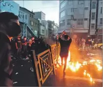  ?? AFP/Getty Images ?? IRANIANS take to the streets of Tehran during a protest for Mahsa Amini on Sept. 21, days after she died in police custody.