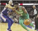  ?? AP PHOTO ?? PUSH IT: Jaylen Brown drives past Philadelph­ia’s Jerryd Bayless during the Celtics’ win yesterday in London.