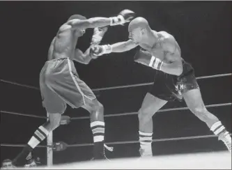  ?? AP-Barry Sweet, File ?? In this November 1974 file photo, Marvin Hagler, right, throws a right at Sugar Ray Seales during a boxing bout in Seattle, which ended in a draw. Hagler, the middleweig­ht boxing great whose title reign and career ended with a split-decision loss to “Sugar” Ray Leonard in 1987, died Saturday. He was 66.