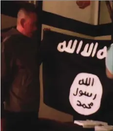  ??  ?? In this July 8 file image taken from FBI video and provided by the U.S. Attorney’s Office in Hawaii on July 13, Army Sgt. 1st Class Ikaika Kang holds an Islamic State group flag after allegedly pledging allegiance to the terror group at a house in...