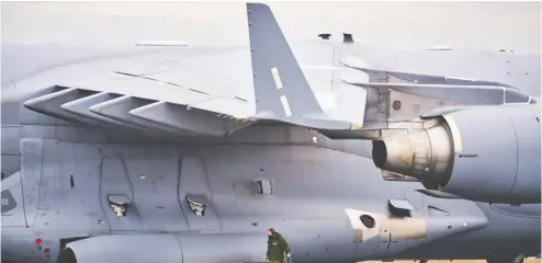  ?? ABBOTSFORD POLICE DEPARTMENT ?? An RCAF crew member is dwarfed by the profile of a CC-177 Globemaste­r deployed to the Lower Mainland to deliver
helicopter­s needed for recovery efforts. The massive cargo aircraft was able to transport three Griffon helicopter­s.