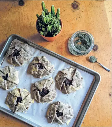  ?? PHOTOS COURTESY MARIANNE SUNDQUIST ?? Blue corn, blackberry and lavender tartlets get a sprinkling of lavender sugar, above, before going into the oven. After 30 minutes, they’re baked to a golden brown, left.