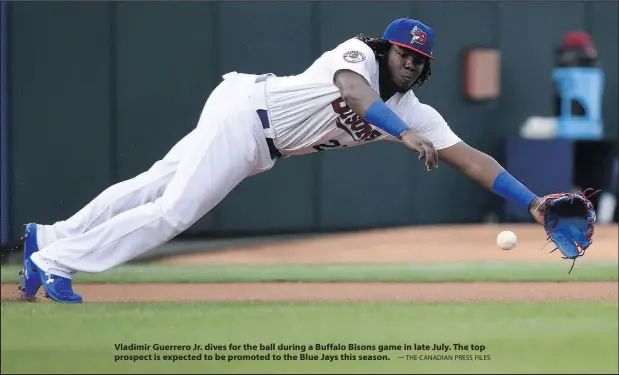 ?? — THE CANADIAN PRESS FILES ?? Vladimir Guerrero Jr. dives for the ball during a Buffalo Bisons game in late July. The top prospect is expected to be promoted to the Blue Jays this season.