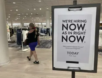  ?? AP FIle ?? HIGHER BUT SLOWER: A Florida department store advertises job openings.