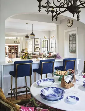  ?? ?? |ABOVE, LEFT| FLOWING FLOOR. The bold floor tile pattern flows from one room to the next in this long hallway. The doors lead to the courtyard, where Celesta grows edible plants to cook with. The stunning, yellow-gold chair belongs to the homeowners.