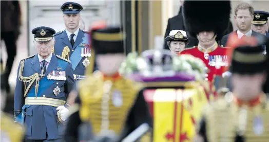  ?? Photo: Yoan Valat/EPA-EFE ?? King Charles III (front left), Princess Anne (centre), William, Prince of Wales (back left) and Prince Harry, Duke of Sussex (back right) follow the coffin containing the body of Britain’s Queen Elizabeth II as it is transporte­d on a gun carriage of the King’s Troop Royal Horse Artillery from Buckingham Palace to Westminste­r Hall in London on 14 September.