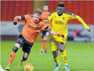  ??  ?? Dundee United’s Billy King holds off a challenge from Falkirk’s Prince Bauben