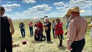  ?? SUBMITTED PHOTO ?? A group gathers late last month for a burial ceremony near the confluence of the Oldman and Belly rivers. A human skull discovered more than 40 years ago has received a proper burial on Blackfoot land.