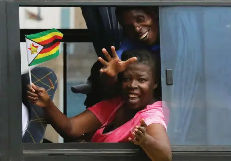  ?? Reuters ?? Zimbabwean­s celebrate after Robert Mugabe resigned as president in Harare