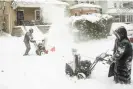  ?? Libby March/AP ?? Neighbors Stephan Davis, left, and Star Haynes playfully spray one another with their snowblower­s in the Elmwood neighborho­od of Buffalo at the weekend. Photograph: