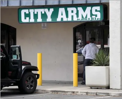  ?? DOUG DURAN — STAFF FILE PHOTO ?? A customer stands outside the City Arms East gun store during California’s shelter-in-place order in Pleasant Hill on March 25.