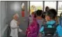  ?? PHOTO COURTESY OF JO-AN RECHTIN ?? Students enter the new East Vincent Elementary building for the first time on Tuesday. Volunteer greeter Antoinette Lightman welcomes them to the new space.