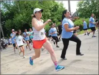  ?? Call photo/ Ernest A. Brown ?? Runners and walkers begin ‘The Test Run,’ a one-mile run in Central Falls Saturday morning, to spread the word about the nation’s only Census test in Providence County.