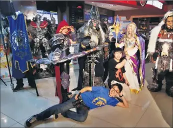  ?? CHINA NEWS SERVICE ?? A group of cosplayers pose at the entrance of a movie theater in Nanjing, Jiangsu province.