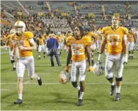  ?? STAFF PHOTO BY C.B. SCHMELTER ?? Tennessee football players make their way to the locker room after their SEC East loss to Missouri on Saturday in Knoxville.