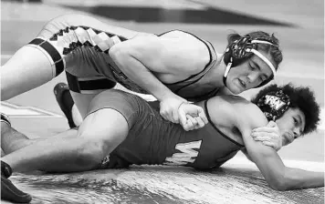  ?? STEPHEN M. DOWELL/ORLANDO SENTINEL ?? Hagerty High wrestler Kamdon Harrison, top, is pictured during a varsity wrestling match at Hagerty High School in Oviedo on Jan. 13.