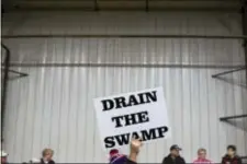  ?? EVAN VUCCI - THE ASSOCIATED PRESS ?? In this 2016 photo, supporters of then-Republican presidenti­al candidate Donald Trump hold signs during a campaign rally in Springfiel­d, Ohio. The Trump administra­tion insists that “drain the swamp” is more than a throwaway catchphras­e, yet in the last...