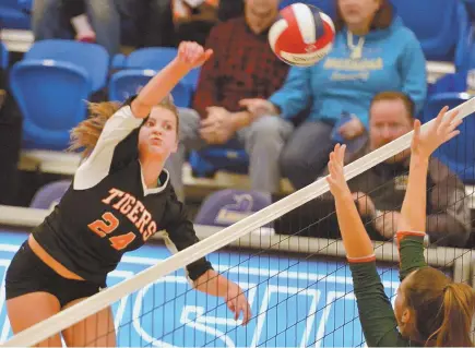  ?? staff photo by ChRIs ChRIsto ?? HEAVY HITTER: Newton North’s Julia Lanfear spikes a shot at Hopkinton’s Jill Czerepuszk­o during yesterday’s Division 1 state volleyball final at Worcester State. The Tigers won a tightly contested sweep.