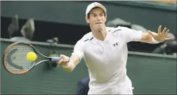  ?? KIRSTY WIGGLESWOR­TH – THE ASSOCIATED PRESS ?? Andy Murray hits a return to Alexander Bublik during their singles match on Monday at Wimbledon.