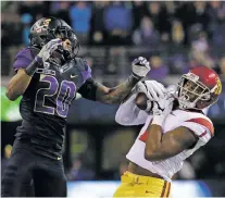  ?? ELAINE THOMPSON/ASSOCIATED PRESS FILE PHOTO ?? USC wide receiver Darreus Rogers, right, makes a catch in November in front of Washington defensive back Kevin King in Seattle. The Huskies and Trojans are favorites in the Pac-12 North and South divisions, respective­ly, as well as national...