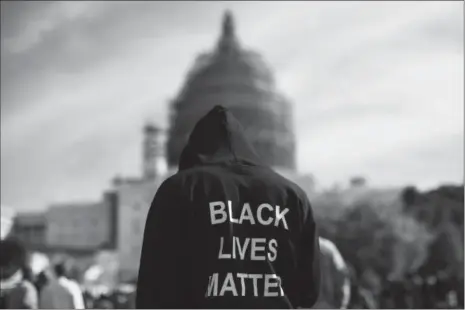  ?? Evan Vucci/Associated Press ?? Neal Blair, of Augusta, Georgia, wears a hoodie which reads “Black Lives Matter” as stands on the lawn of the Capitol building during a rally to mark the 20th anniversar y of the Million Man March, on Capitol Hill, on Saturday, Oct. 10in Washington....