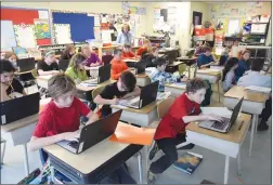  ?? NEWS PHOTO EMMA BENNETT ?? Grade 5 students work Thursday during social studies class at St. Michael's School. Alberta educators and the province have reached a two-year agreement.