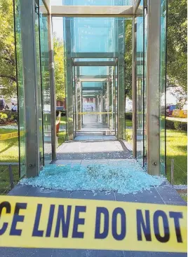  ?? STAFF PHOTOS, ABOVE AND BELOW, BY ANGELA ROWLINGS; POOL PHOTO, LEFT ?? ‘SACRED PLACE’: James E. Isaac, at left with his lawyer, is arraigned on charges related to vandalism of the New England Holocaust Memorial, above. Below, Holocaust survivor Izzy Arbeiter, 92, holds a piece of glass from the memorial’s shattered glass...