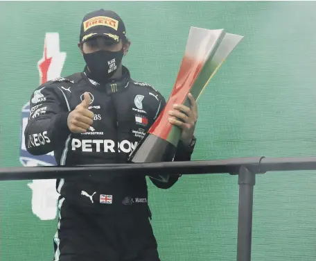  ??  ?? Mercedes driver Lewis Hamilton celebrates after winning the Formula One Portuguese Grand Prix at the Algarve Internatio­nal Circuit in Portugal.