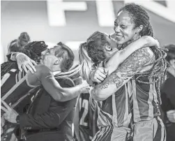  ?? FIBA ?? Brittney Griner, right, celebrates winning her fourth EuroLeague women's basketball title Sunday with her Russian team UMMC Ekaterinbu­rg. Griner next will play for the WNBA Phoenix Mercury in summer 2021.