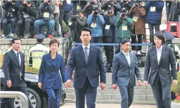  ?? —Reuters photo ?? Park (second left) arrives for questionin­g on her arrest warrant at the Seoul Central District Court in Seoul, South Korea.
