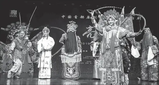  ?? PHOTOS PROVIDED TO CHINA DAILY ?? Performers of the new Peking Opera production, Liang Xiang, strike a pose onstage at Tian Le Yuan Theater in Beijing on Dec 19.