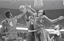  ?? AP Photo/Eric Gay ?? Florida A&M forward Desmond Williams (0) is blocked by Texas forward Royce Hamm Jr. (5) as he tries to score in the first half Wednesday in Austin.