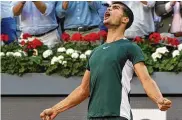 ?? PAUL WHITE/ASSOCIATED PRESS ?? Carlos Alcaraz, of Spain, celebrates after winning the final match against Alexander Zverev, of Germany, at the Mutua Madrid Open tennis tournament in Madrid, Spain, Sunday.