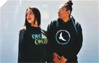  ?? Photo by Dee Helson Rude Gang. ?? Casey Desjarlais wears a Decolonial long-sleeve shirt while her partner, Dakota Bear, sports one of their Indigenous-owned company’s black hoodies.
