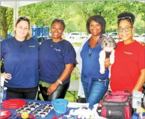  ??  ?? Meg Moier of West Grove, Mistie Graham of Philadelph­ia, along with Wayne gals Sheree Minor and Veronica Durham, give away “fun in the sun” souvenirs from Penn Medicine- Valley Forge.