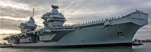  ??  ?? Show of force: The Royal Navy’s £3.2billion Queen Elizabeth aircraft carrier is being deployed to the Pacific with F-35 jets