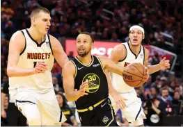  ?? EZRA SHAW — GETTY IMAGES ?? The Warriors’ Stephen Curry (30) is guarded by the Nuggets’ Nikola Jokic, left, in the second half of Game 5 on Wednesday at Chase Center in San Francisco.