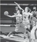  ?? CHARLIE NEIBERGALL/AP ?? Ohio State guard Madison Greene (0) drives to the basket past Iowa guard McKenna Warnock during the first half Wednesday in Iowa City, Iowa.