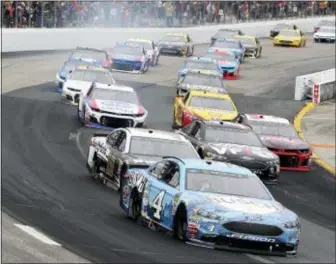  ?? MARY SCHWALM — THE ASSOCIATED PRESS ?? Kevin Harvick races with the pack during a NASCAR Cup Series auto race Sunday at New Hampshire Motor Speedway in Loudon, N.H.