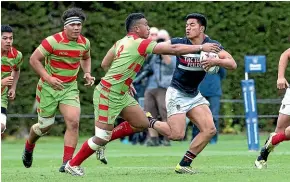  ?? Photo: WARWICK SMITH, STUFF. ?? Turbos player Josiah Maraku, is pictured playing for Feilding High School, as he fends of Tasi James (Aorere) in the 2016 1st XV national finals.